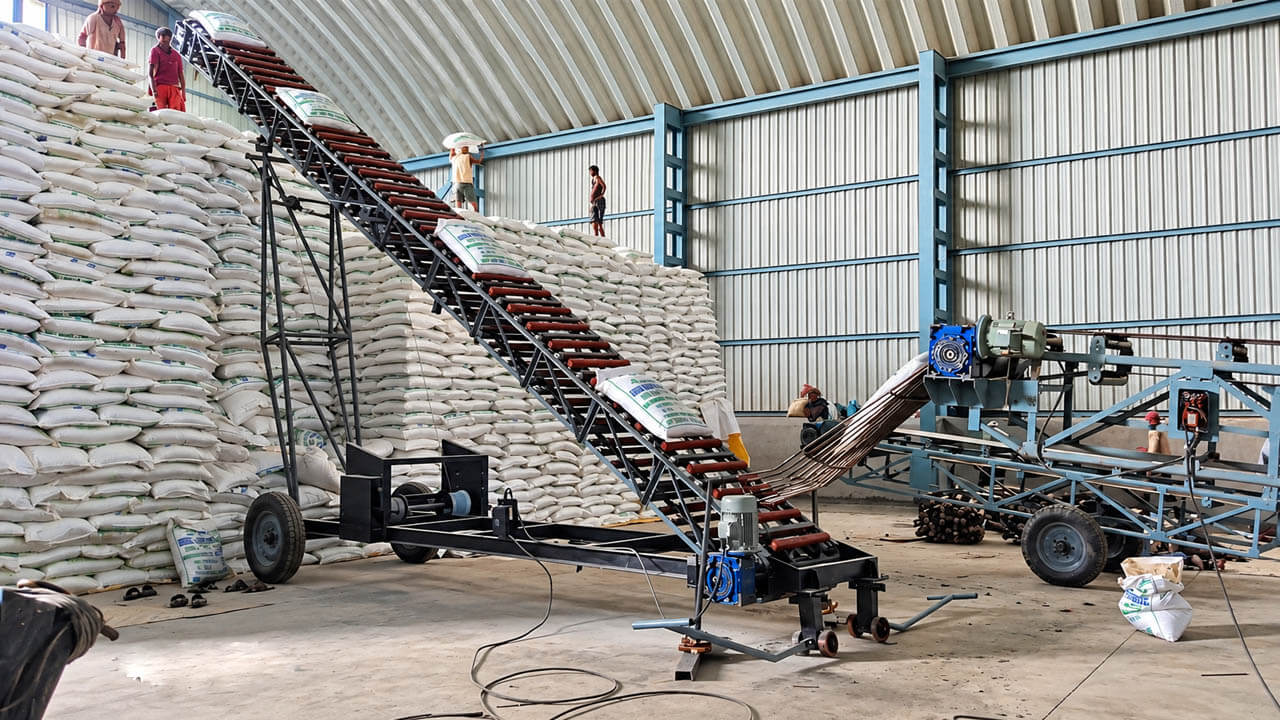 Bag stacker conveyor loading sugar bags in a warehouse